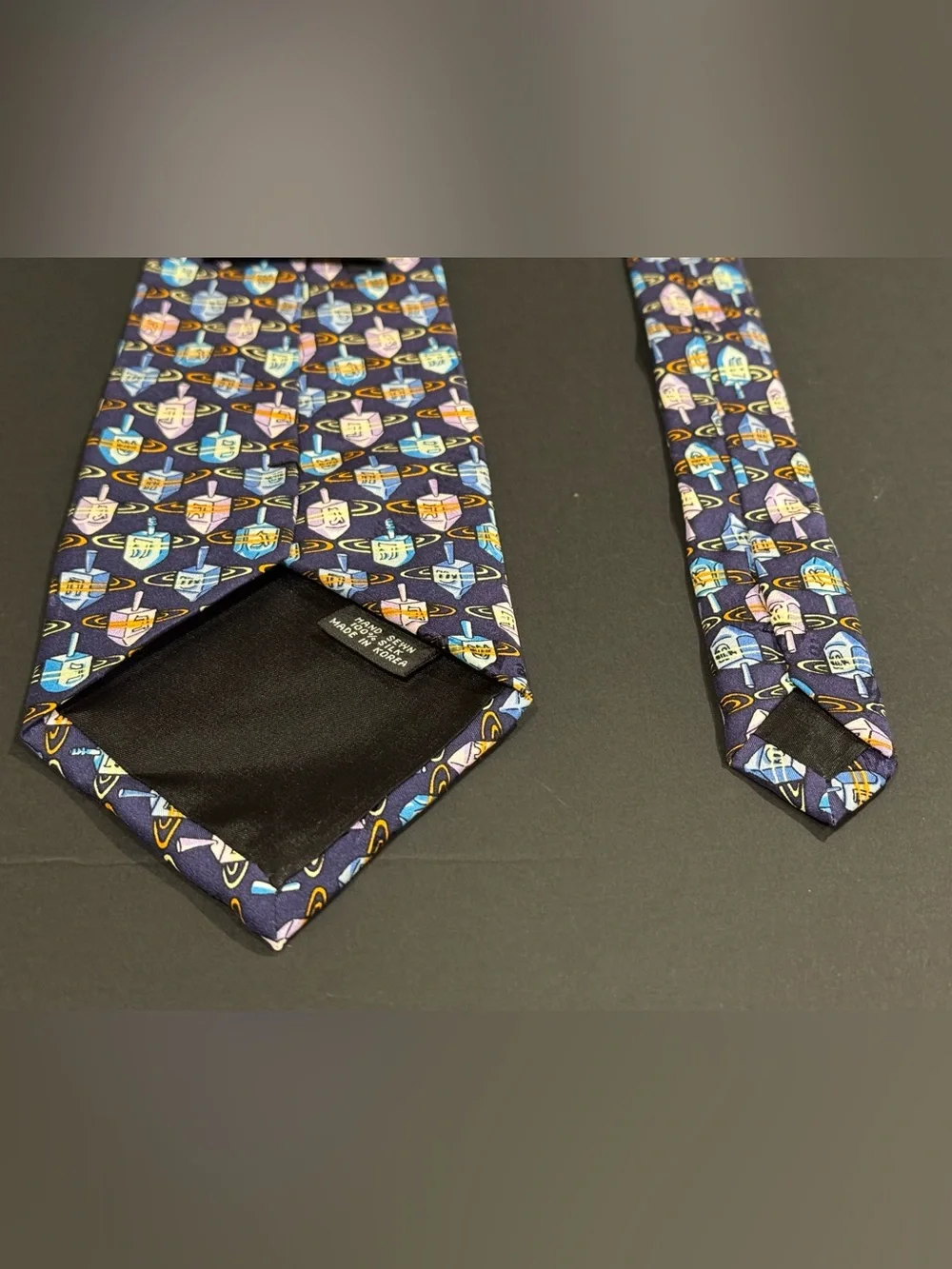 Hanukkah inspired silk tie with dreidel pattern by Nicole Miller NYC